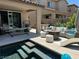 Outdoor patio area by the pool with comfortable seating and a lounge chair at 4138 Bayley Skye Ave, Las Vegas, NV 89141