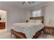 Cozy bedroom with wood frame bed, wood nightstand, and soothing neutral tones at 4138 Bayley Skye Ave, Las Vegas, NV 89141