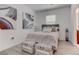 Cozy bedroom with stylish decor, including neutral-toned bedding and decorative artwork at 4138 Bayley Skye Ave, Las Vegas, NV 89141