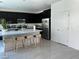 Bright kitchen featuring black cabinets, a large center island, and stainless steel appliances at 4138 Bayley Skye Ave, Las Vegas, NV 89141