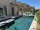 Inviting private pool and backyard area with outdoor seating and lounge chairs at 4138 Bayley Skye Ave, Las Vegas, NV 89141