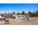 Wide view of the single-story home with a metal roof, spacious yard, and partial fencing at 432 Bonelli Ave, Overton, NV 89040