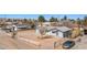 Wide aerial shot of the property, revealing its metal roof, desert landscape, fenced yard, and neighborhood at 432 Bonelli Ave, Overton, NV 89040