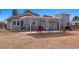 The backyard featuring a covered patio and desert landscaping at 432 Bonelli Ave, Overton, NV 89040