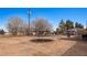 View of a large backyard with a trampoline and covered patio at 432 Bonelli Ave, Overton, NV 89040