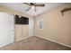 Bedroom with neutral walls, plush carpet, window, and wall-mounted TV at 432 Bonelli Ave, Overton, NV 89040