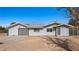 Single-story home featuring light gray siding, grey metal roof, a garage and minimal landscaping at 432 Bonelli Ave, Overton, NV 89040