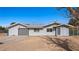 View of gray home featuring a metal roof, attached garage, fenced yard, and covered porch at 432 Bonelli Ave, Overton, NV 89040