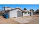 A single-Gathering home featuring a driveway, garage, and light-gray siding under a bright, clear blue sky at 432 Bonelli Ave, Overton, NV 89040