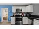 Kitchen view adjacent to living room features stainless appliances and white cabinets at 432 Bonelli Ave, Overton, NV 89040