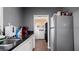 Kitchen and laundry room offers stainless steel appliances, storage and access to laundry at 432 Bonelli Ave, Overton, NV 89040