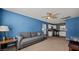 A living room featuring a sofa, ceiling fan, and a view into the kitchen at 432 Bonelli Ave, Overton, NV 89040