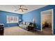 A living room with a ceiling fan, sofa, and view into another room at 432 Bonelli Ave, Overton, NV 89040
