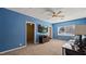 Cozy living room features blue accent wall, ceiling fan, large TV, and comfortable seating at 432 Bonelli Ave, Overton, NV 89040