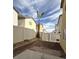 Spacious backyard area is surrounded by a fence and features a young palm tree at 4356 Pittsfield St, Las Vegas, NV 89115