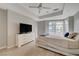 Serene bedroom showcasing a large window, modern ceiling fan, stylish dresser with TV, and unique bed frame at 4515 Dean Martin Dr # 200, Las Vegas, NV 89103