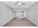 Well-lit bedroom featuring neutral walls and carpet, a ceiling fan and mirrored closet doors at 4655 Gold Dust Ave # 139, Las Vegas, NV 89120