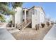 Beige stucco condo building featuring multiple units and exterior staircases on a sunny day at 4655 Gold Dust Ave # 139, Las Vegas, NV 89120