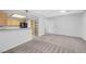 Bright living room featuring neutral carpet and a view into the open kitchen area with light cabinetry at 4655 Gold Dust Ave # 139, Las Vegas, NV 89120