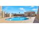 Community pool featuring clear blue water, poolside seating, and a pool house on a sunny day at 4655 Gold Dust Ave # 139, Las Vegas, NV 89120