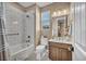 Bright bathroom with tub shower, vanity, tile walls and neutral color palette at 500 Pear Lake St, Las Vegas, NV 89138