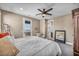Comfortable bedroom with a ceiling fan, a private balcony, and modern decor at 500 Pear Lake St, Las Vegas, NV 89138