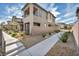 A modern home with a sidewalk, rock landscaping, and a backyard patio at 500 Pear Lake St, Las Vegas, NV 89138