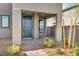 Inviting front entrance with a blue front door, a covered porch, and desert landscaping at 500 Pear Lake St, Las Vegas, NV 89138