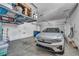 Spacious garage with ample storage shelves and a modern electric car at 500 Pear Lake St, Las Vegas, NV 89138