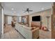 Spacious living room featuring modern ceiling fan, hardwood floors and adjacent eat-in kitchen at 500 Pear Lake St, Las Vegas, NV 89138