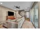 Relaxing living room with comfortable sofa, wooden floors, entertainment center and a ceiling fan at 500 Pear Lake St, Las Vegas, NV 89138