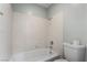 Clean bathroom with a white tiled shower/tub combo and modern fixtures at 5111 Rudy Ln, Las Vegas, NV 89120