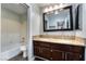 Bathroom with double sinks, granite countertops, and a shower and tub at 5111 Rudy Ln, Las Vegas, NV 89120