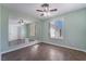 Bedroom featuring tile flooring, a ceiling fan, and a mirrored wall at 5111 Rudy Ln, Las Vegas, NV 89120