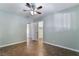 A cozy bedroom featuring a ceiling fan, tile floors, neutral paint and an open closet at 5111 Rudy Ln, Las Vegas, NV 89120