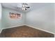 A well-lit bedroom featuring tile floors, a ceiling fan, and a view to the outdoor patio at 5111 Rudy Ln, Las Vegas, NV 89120