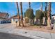 Charming single-story home with desert landscaping, mature palm trees, and stone accents at 5111 Rudy Ln, Las Vegas, NV 89120