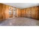 An enclosed wood paneled patio featuring a sliding door entrance to the main house at 5111 Rudy Ln, Las Vegas, NV 89120