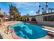 Backyard pool with mature trees and desert landscaping at 5111 Rudy Ln, Las Vegas, NV 89120