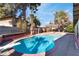 Backyard pool with mature trees and desert landscaping at 5111 Rudy Ln, Las Vegas, NV 89120