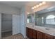 Bright bathroom featuring double sink vanity, walk-in shower, and soaking tub at 5596 Danforth Ave, Las Vegas, NV 89141