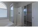 Bathroom with soaking tub, glass enclosed shower, and walk-in closet at 5596 Danforth Ave, Las Vegas, NV 89141