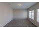 Clean bedroom with neutral carpet, gray walls, natural light and recessed lighting at 5596 Danforth Ave, Las Vegas, NV 89141