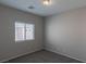 Neutral bedroom with carpet, window with blinds, and ceiling light at 5596 Danforth Ave, Las Vegas, NV 89141