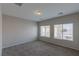 Bright bedroom with neutral carpet, gray walls, and natural light through two windows at 5596 Danforth Ave, Las Vegas, NV 89141