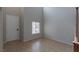 Open foyer area with tile flooring, high ceiling, and a view of the front door at 5596 Danforth Ave, Las Vegas, NV 89141