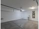 Clean, empty garage with a white door, water heater, and grey concrete floor at 5596 Danforth Ave, Las Vegas, NV 89141