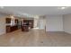 Open-concept living space featuring tile floors, adjacent kitchen with dark wood cabinets and island at 5596 Danforth Ave, Las Vegas, NV 89141