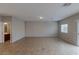 Spacious living area with tile flooring, neutral walls, and a view to the adjacent bathroom at 5596 Danforth Ave, Las Vegas, NV 89141