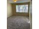 Spacious bedroom with plush carpet, bright window views, and neutral walls at 5710 E Tropicana Ave # 2047, Las Vegas, NV 89122